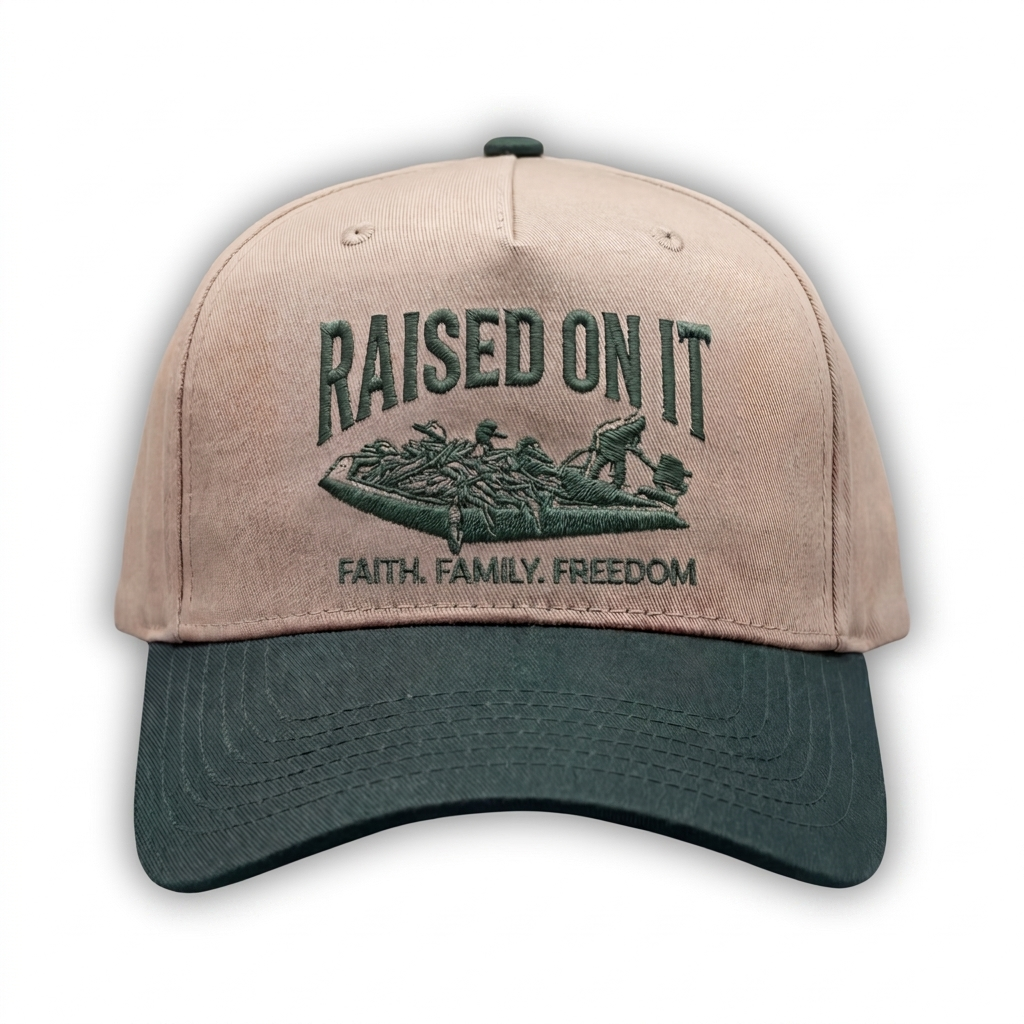 Outboard Legacy Hat in Mudboat (green brim, green stitch) with embroidered Raised On It mud boat logo and Faith Family Freedom