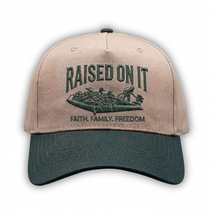 Outboard Legacy Hat in Mudboat (green brim, green stitch) with embroidered Raised On It mud boat logo and Faith Family Freedom