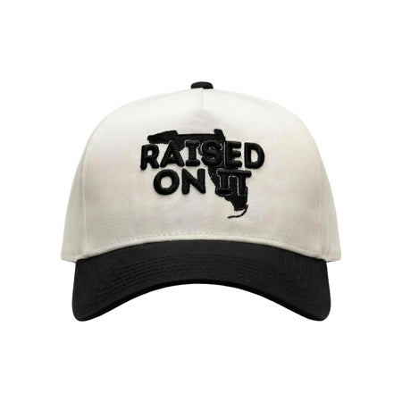 Raised On It Florida Logo embroidered trucker hat in White/Black, canvas white crown, black bill, black Florida logo stitch