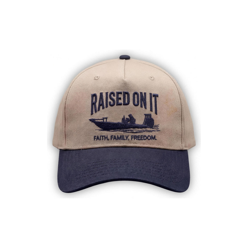 Outboard Legacy Hat in Skiff (navy brim, navy stitch) with embroidered Raised On It skiff logo and Faith Family Freedom