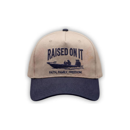 Outboard Legacy Hat in Skiff (navy brim, navy stitch) with embroidered Raised On It skiff logo and Faith Family Freedom