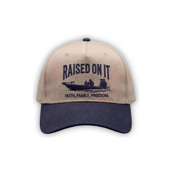 Outboard Legacy Hat in Skiff (navy brim, navy stitch) with embroidered Raised On It skiff logo and Faith Family Freedom